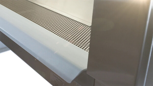 Nuaire biosafety cabinet armrest and airflow grill close up.